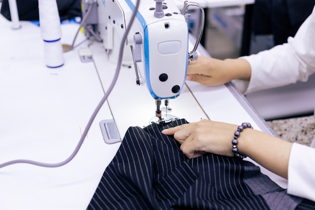 a-woman-using-a-sewing-machine-to-sew-clothes-upkxvfgkaby